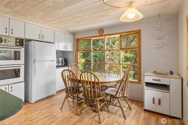 dining space featuring wood ceiling, plenty of natural light, and light wood-type flooring