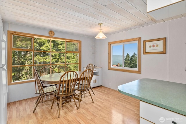 dining space with plenty of natural light, wooden ceiling, and light wood-style floors