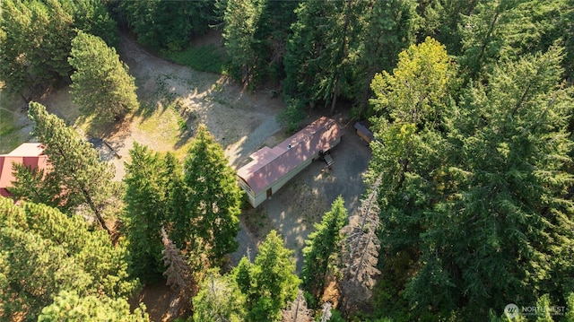 drone / aerial view featuring a forest view