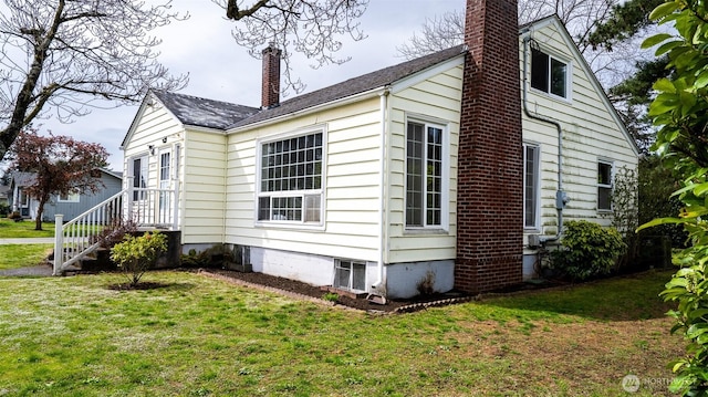view of property exterior with a chimney and a yard