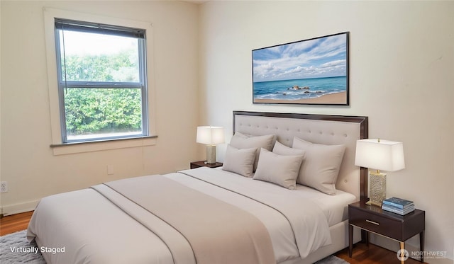 bedroom with wood finished floors