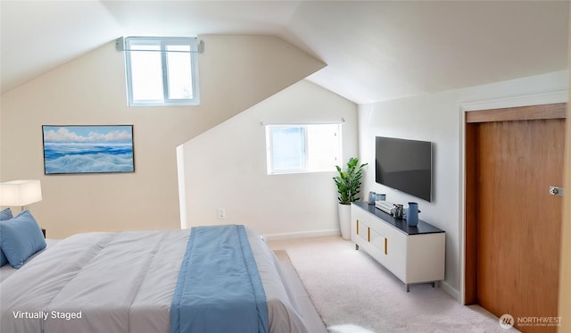 bedroom featuring multiple windows, light colored carpet, baseboards, and lofted ceiling