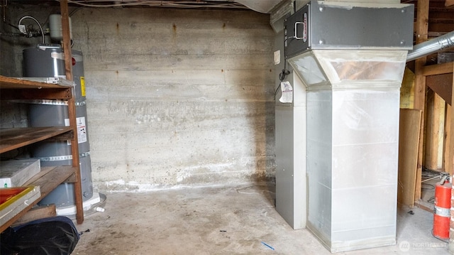 unfinished basement with strapped water heater and heating unit