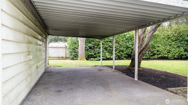 view of patio featuring an attached carport and fence