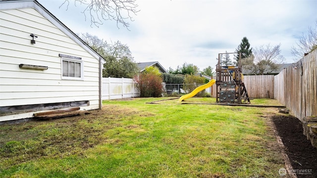 view of yard featuring a fenced backyard and a playground