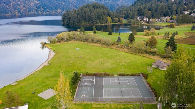 aerial view featuring a water view and a wooded view