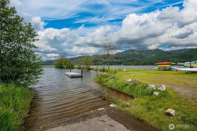 view of dock featuring a water and mountain view
