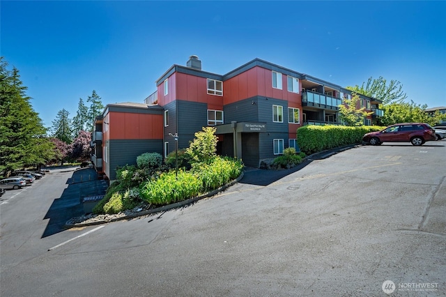 7021 Sand Point Way Unit B319, Seattle, WA 98115 - view of building exterior featuring uncovered parking