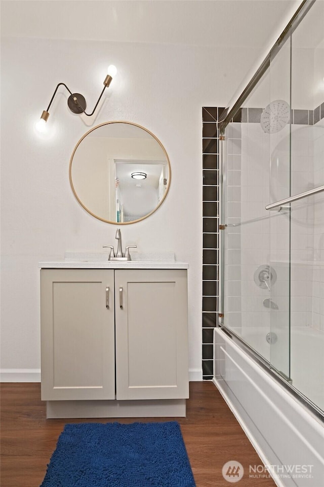 7021 Sand Point Way Unit B319, Seattle, WA 98115 - full bath with shower / bath combination with glass door, wood finished floors, vanity, and baseboards