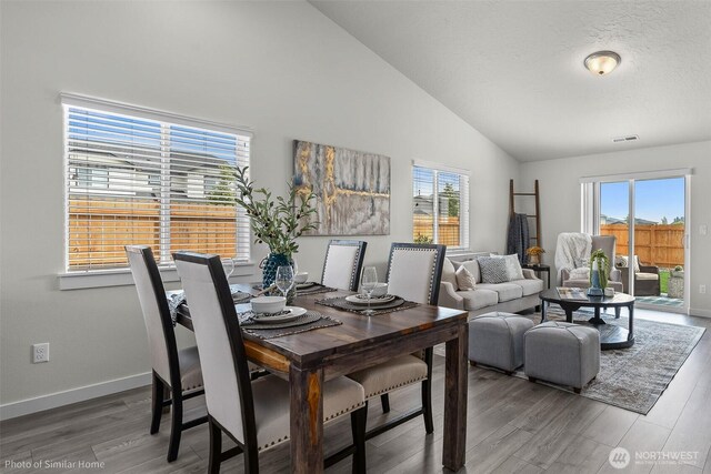705 Ava St, Walla Walla, WA 99362 - dining room featuring lofted ceiling, healthy amount of natural light, wood finished floors, and baseboards