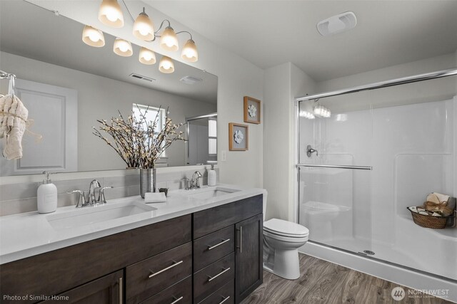 705 Ava St, Walla Walla, WA 99362 - bathroom with toilet, wood finished floors, double vanity, and a shower stall