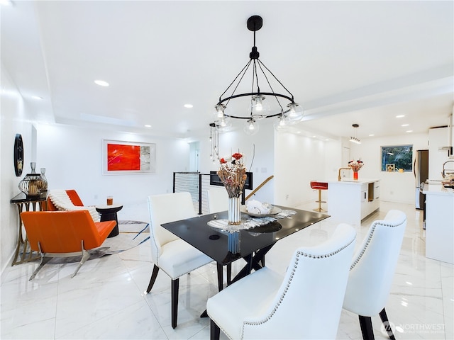dining area with marble finish floor, recessed lighting, and a chandelier