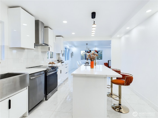 kitchen featuring a kitchen island, white cabinetry, wall chimney exhaust hood, stainless steel dishwasher, and electric stove