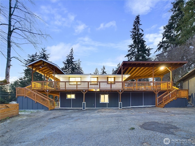 view of front of house featuring stairs and a deck