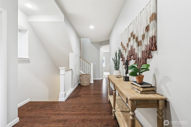 corridor with baseboards, wood finished floors, recessed lighting, and stairway