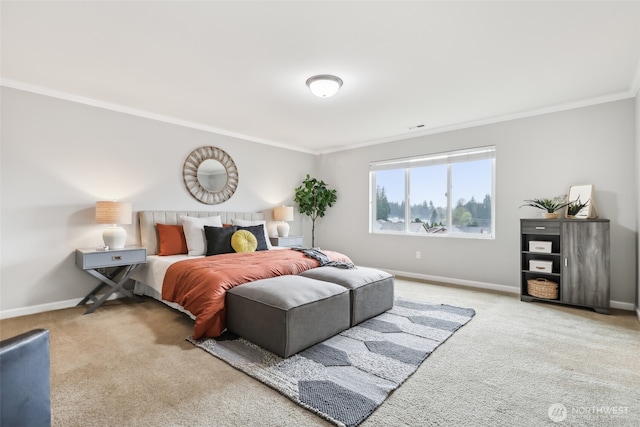 carpeted bedroom featuring visible vents, baseboards, and crown molding