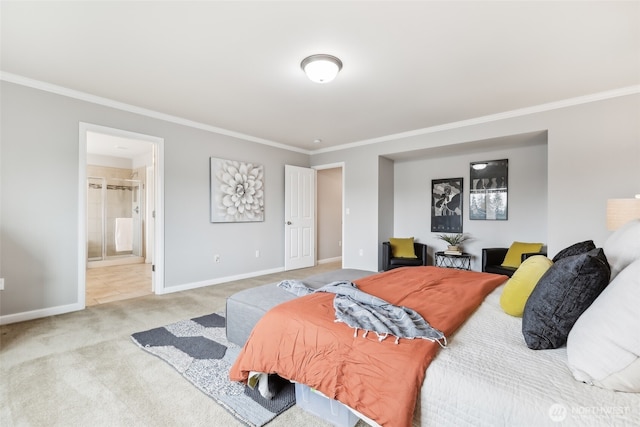 carpeted bedroom with ensuite bath, crown molding, and baseboards