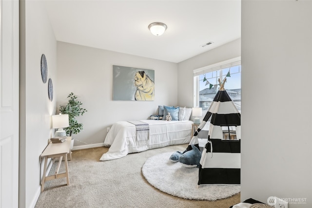 carpeted bedroom with baseboards and visible vents