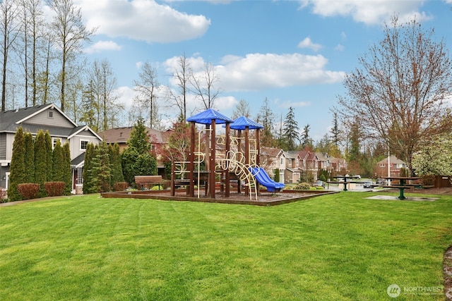 communal playground featuring a lawn