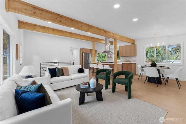 living room with beamed ceiling, recessed lighting, a notable chandelier, and light wood-style floors