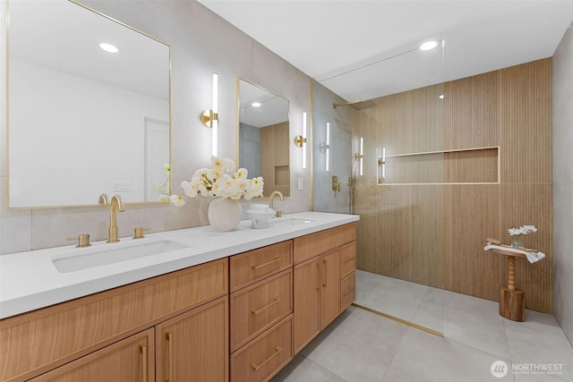 full bathroom featuring a sink, tile patterned floors, walk in shower, and double vanity
