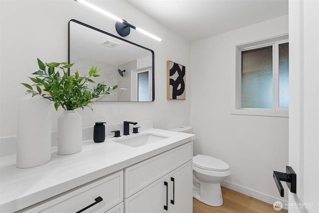 full bath with vanity, toilet, visible vents, a shower, and wood finished floors