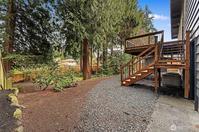 view of yard featuring stairway and fence