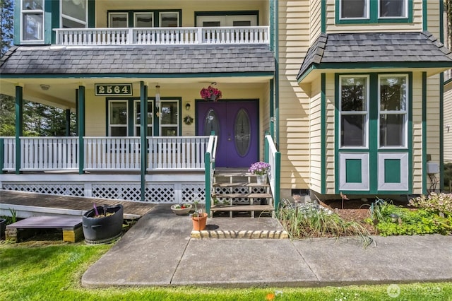 property entrance featuring a porch and a balcony