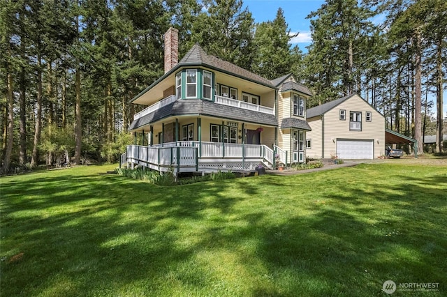 view of front facade featuring a front lawn, a balcony, a chimney, and covered porch