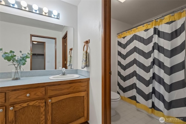 bathroom featuring vanity, tile patterned flooring, a shower with shower curtain, and toilet