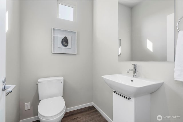 13815 Brookdale Ln E Unit 107, Tacoma, WA 98445 - bathroom featuring toilet, wood finished floors, and baseboards