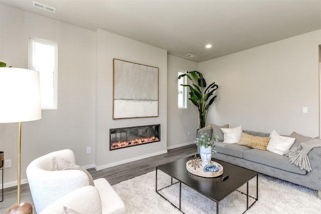 13815 Brookdale Ln E Unit 107, Tacoma, WA 98445 - living room with a glass covered fireplace, baseboards, recessed lighting, visible vents, and wood finished floors