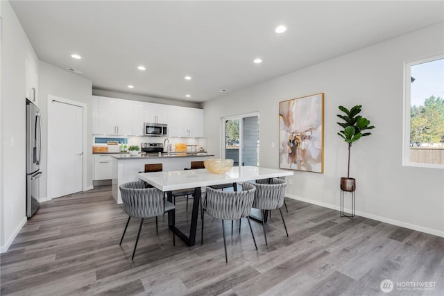 13815 Brookdale Ln E Unit 107, Tacoma, WA 98445 - dining area with recessed lighting, baseboards, and wood finished floors
