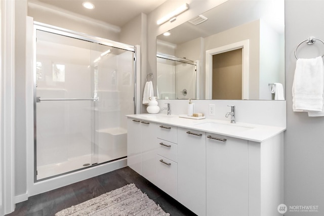 13815 Brookdale Ln E Unit 107, Tacoma, WA 98445 - bathroom with double vanity, visible vents, a sink, and a stall shower
