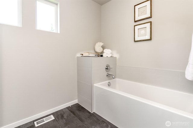 13815 Brookdale Ln E Unit 107, Tacoma, WA 98445 - full bathroom with visible vents, baseboards, and a garden tub