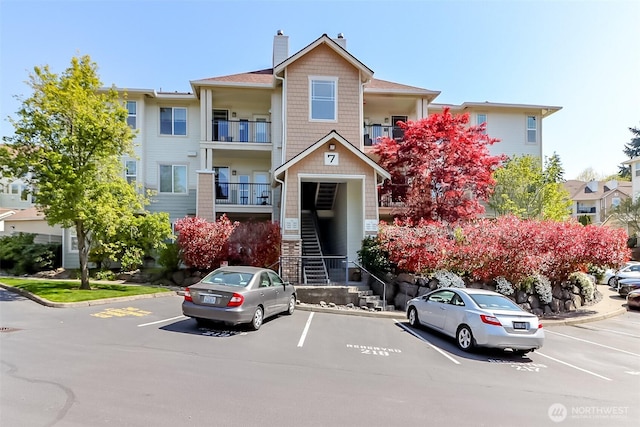 15026 40th Ave W Unit 7-203, Lynnwood, WA 98087 - view of property featuring uncovered parking and stairs