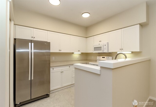 15026 40th Ave W Unit 7-203, Lynnwood, WA 98087 - kitchen featuring white cabinetry, light countertops, freestanding refrigerator, electric stove, and white microwave