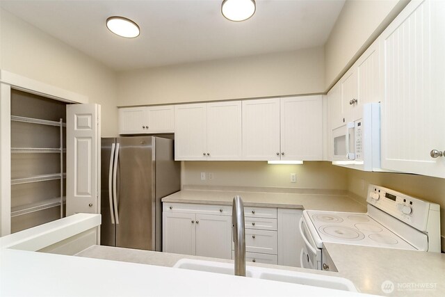 15026 40th Ave W Unit 7-203, Lynnwood, WA 98087 - kitchen featuring white cabinetry, white appliances, light countertops, and a sink