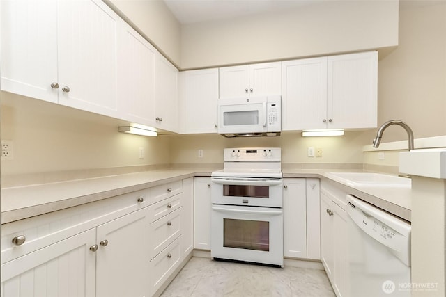 15026 40th Ave W Unit 7-203, Lynnwood, WA 98087 - kitchen featuring white cabinets, a sink, light countertops, white appliances, and marble finish floor