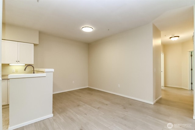 15026 40th Ave W Unit 7-203, Lynnwood, WA 98087 - interior space featuring light wood finished floors, a sink, and baseboards