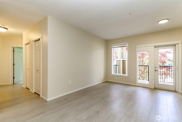 15026 40th Ave W Unit 7-203, Lynnwood, WA 98087 - unfurnished room with light wood-style flooring, a wealth of natural light, and baseboards