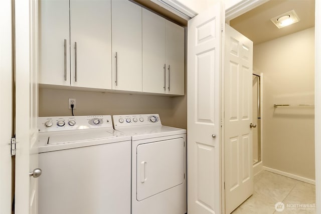 15026 40th Ave W Unit 7-203, Lynnwood, WA 98087 - clothes washing area featuring baseboards, separate washer and dryer, cabinet space, and light tile patterned flooring
