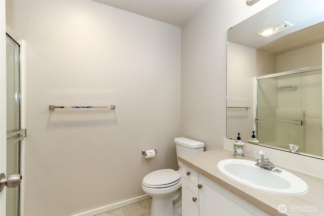 15026 40th Ave W Unit 7-203, Lynnwood, WA 98087 - bathroom featuring tile patterned floors, an enclosed shower, toilet, vanity, and baseboards