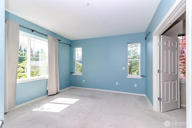 15026 40th Ave W Unit 7-203, Lynnwood, WA 98087 - empty room featuring a wealth of natural light, carpet flooring, and baseboards