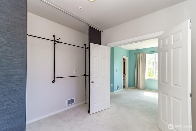 15026 40th Ave W Unit 7-203, Lynnwood, WA 98087 - unfurnished bedroom featuring visible vents, baseboards, and light carpet