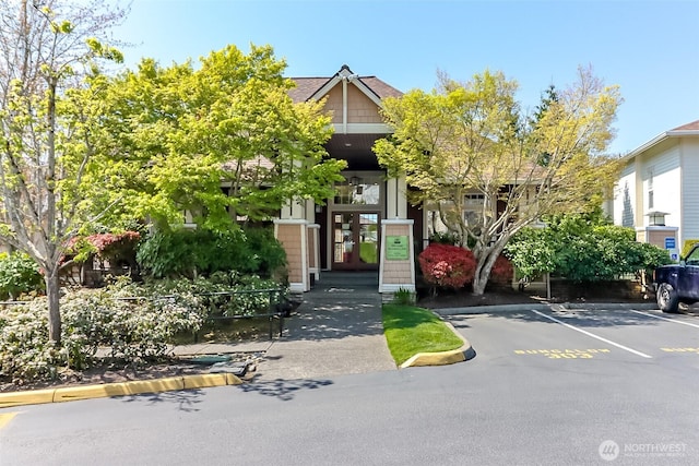 15026 40th Ave W Unit 7-203, Lynnwood, WA 98087 - view of front facade featuring uncovered parking and french doors