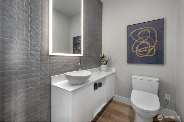 1515 141st St E Unit 72, Tacoma, WA 98445 - bathroom featuring toilet, vanity, wood finished floors, and baseboards
