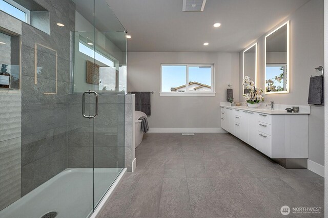 1515 141st St E Unit 72, Tacoma, WA 98445 - full bath with baseboards, a shower stall, double vanity, a soaking tub, and recessed lighting