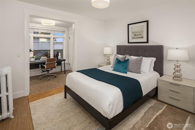 bedroom with baseboards and wood finished floors