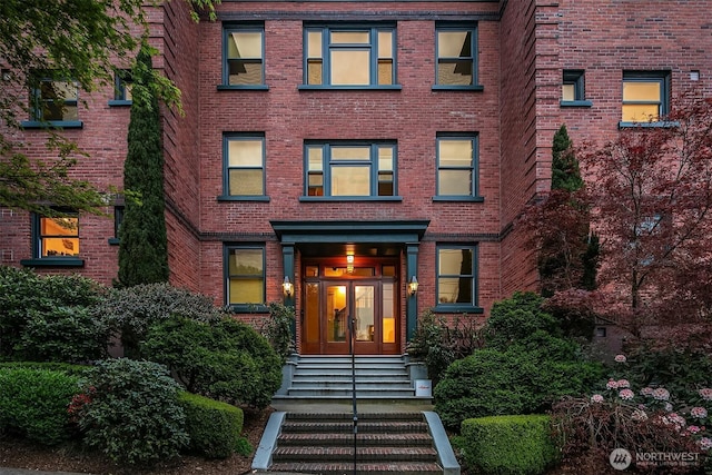 view of front of property featuring brick siding and french doors